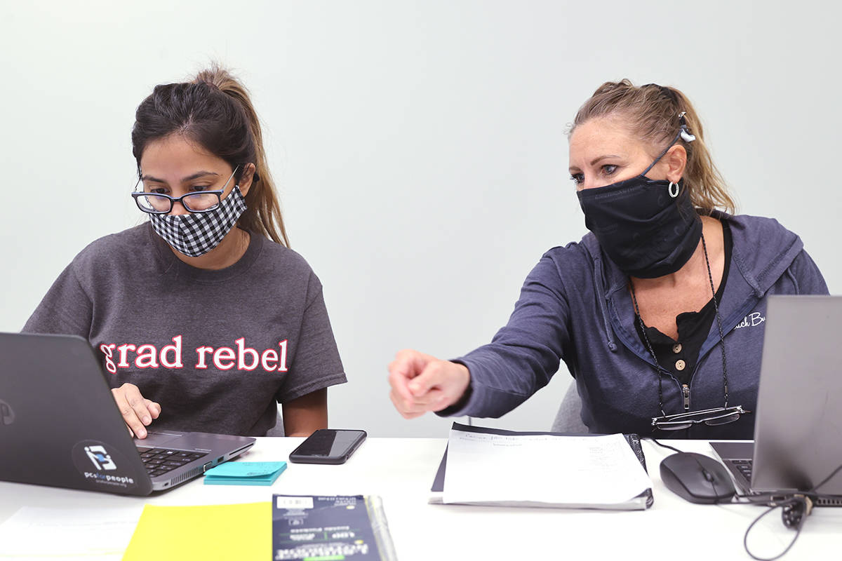 Jenn Bowers, senior disease investigator with Southern Nevada Health District, right, works on ...