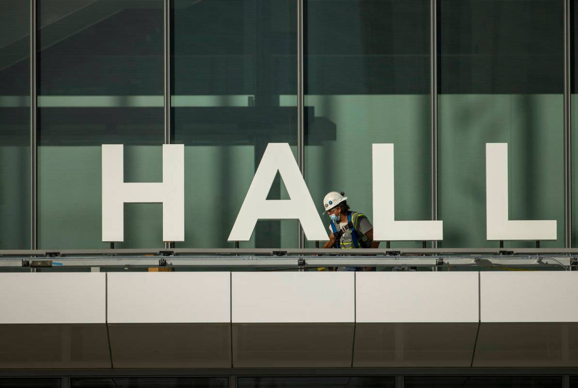 A worker moves about as construction continues out front of the new Las Vegas Convention Center ...