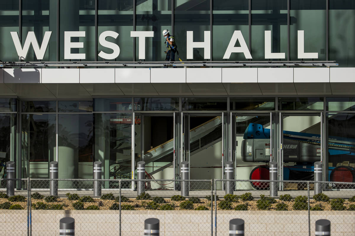 A worker moves about as construction continues out front of the new Las Vegas Convention Center ...