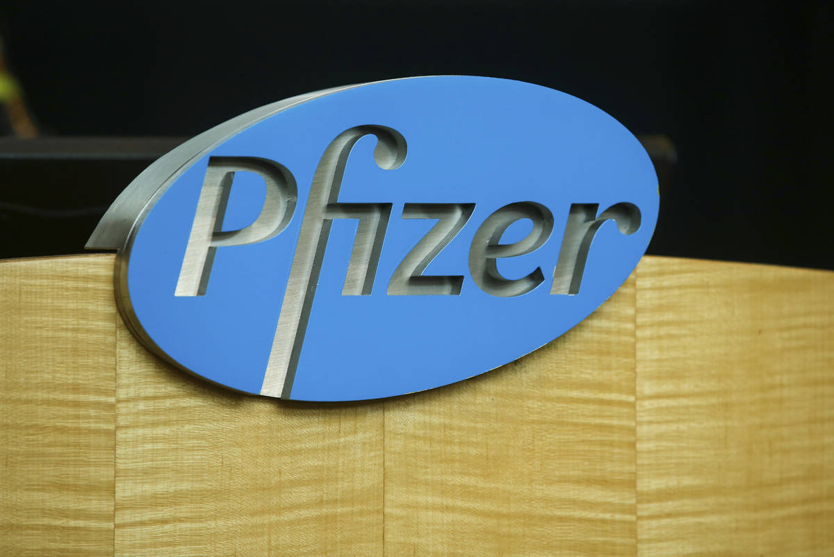 FILE - In this file photo dated Wednesday, July 22, 2020, a Pfizer sign is seen on a podium at ...