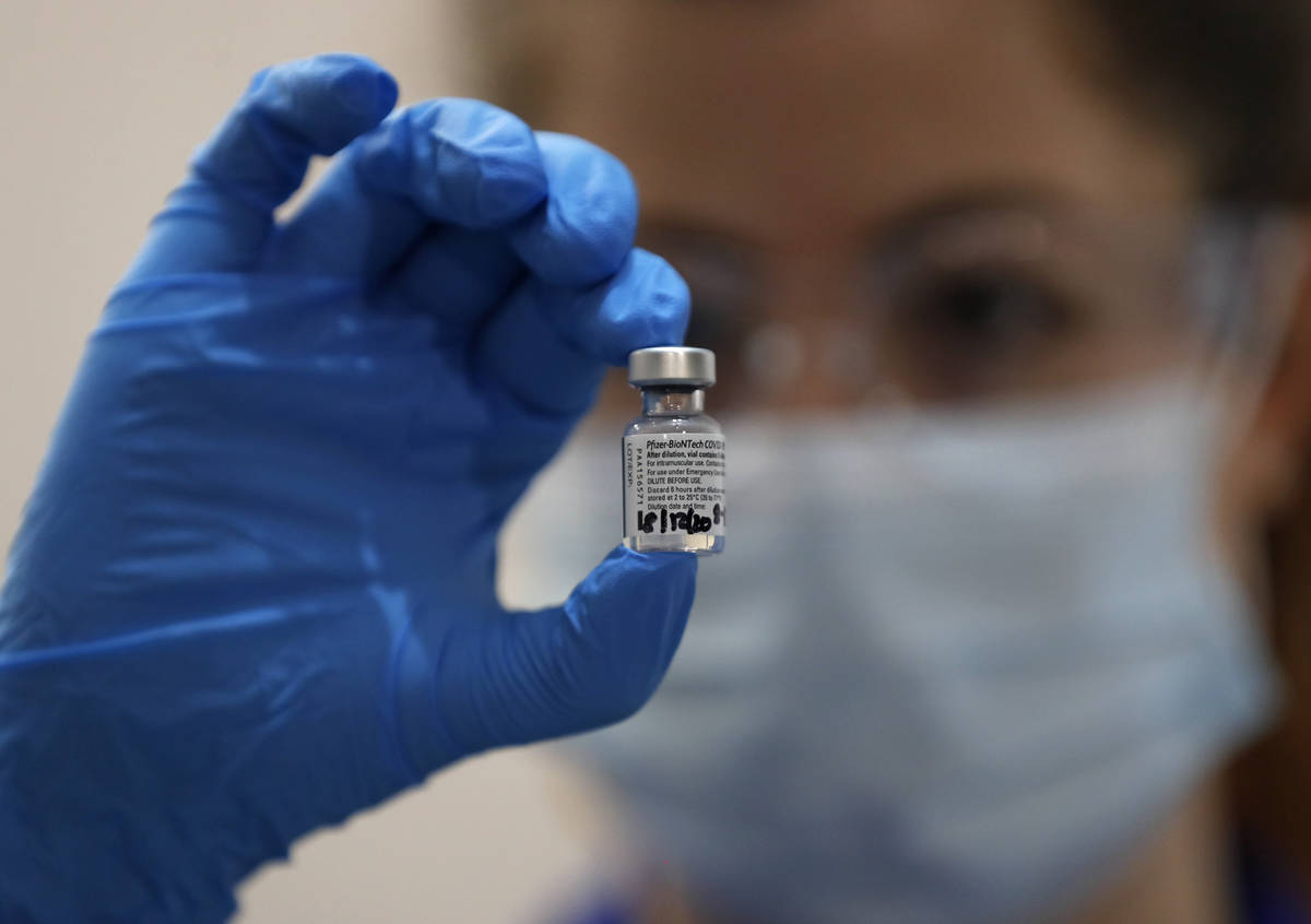A nurse holds a phial of the Pfizer-BioNTech COVID-19 vaccine at Guy's Hospital in London, Tues ...