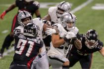 Las Vegas Raiders running back Devontae Booker (23) rushes past Atlanta Falcons defensive tackl ...