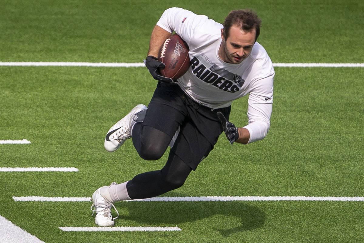 Las Vegas Raiders wide receiver Hunter Renfrow runs with the football before an NFL football ga ...