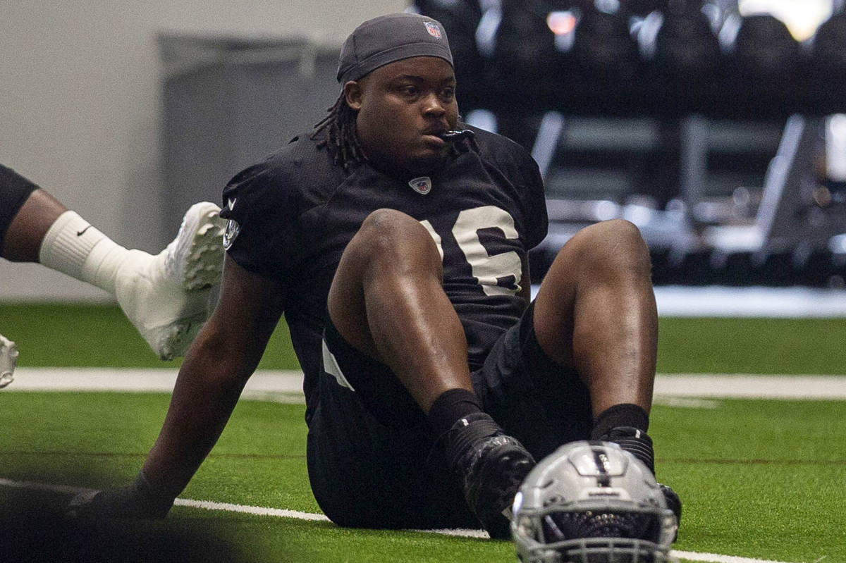 Las Vegas Raiders offensive guard John Simpson (76) stretches during a practice session at the ...