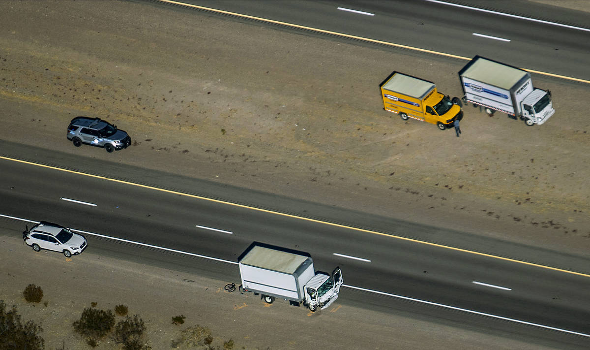 Damage to a truck is evident as the Nevada Highway Patrol works the scene of a fatal crash invo ...