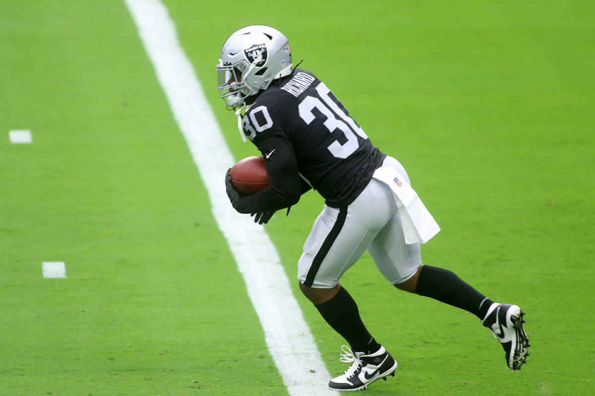 Las Vegas Raiders running back Jalen Richard (30) runs with the football during a team practice ...