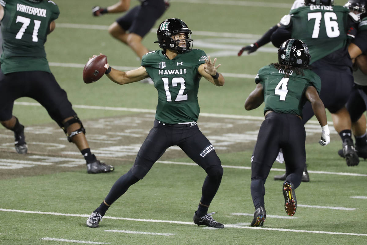 Hawaii quarterback Chevan Cordeiro (12) looks for a receiver during the first half against UNLV ...