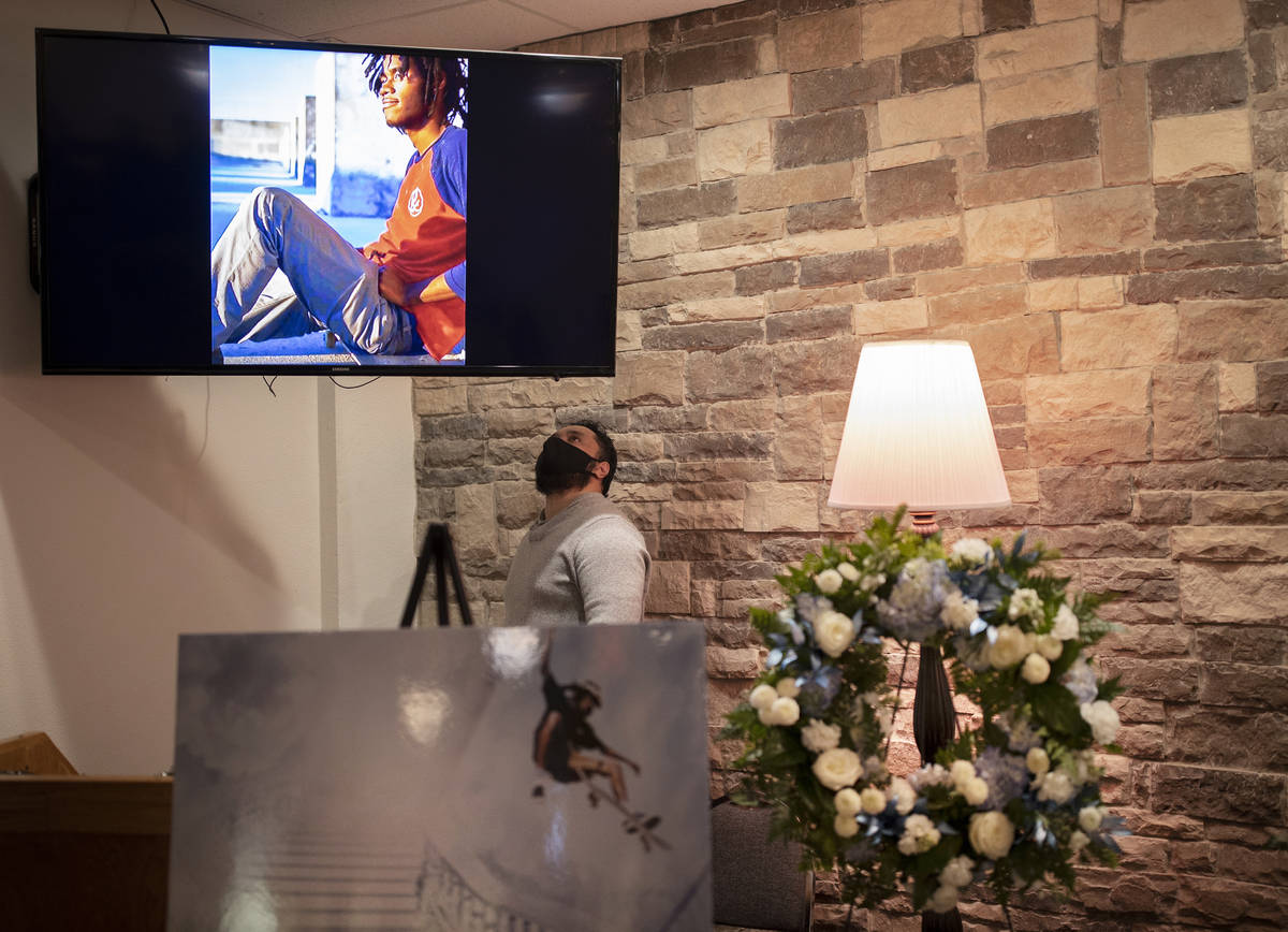 Malu Seiuli looks at a photo of Genesis Atkins during a memorial service for the competitive s ...