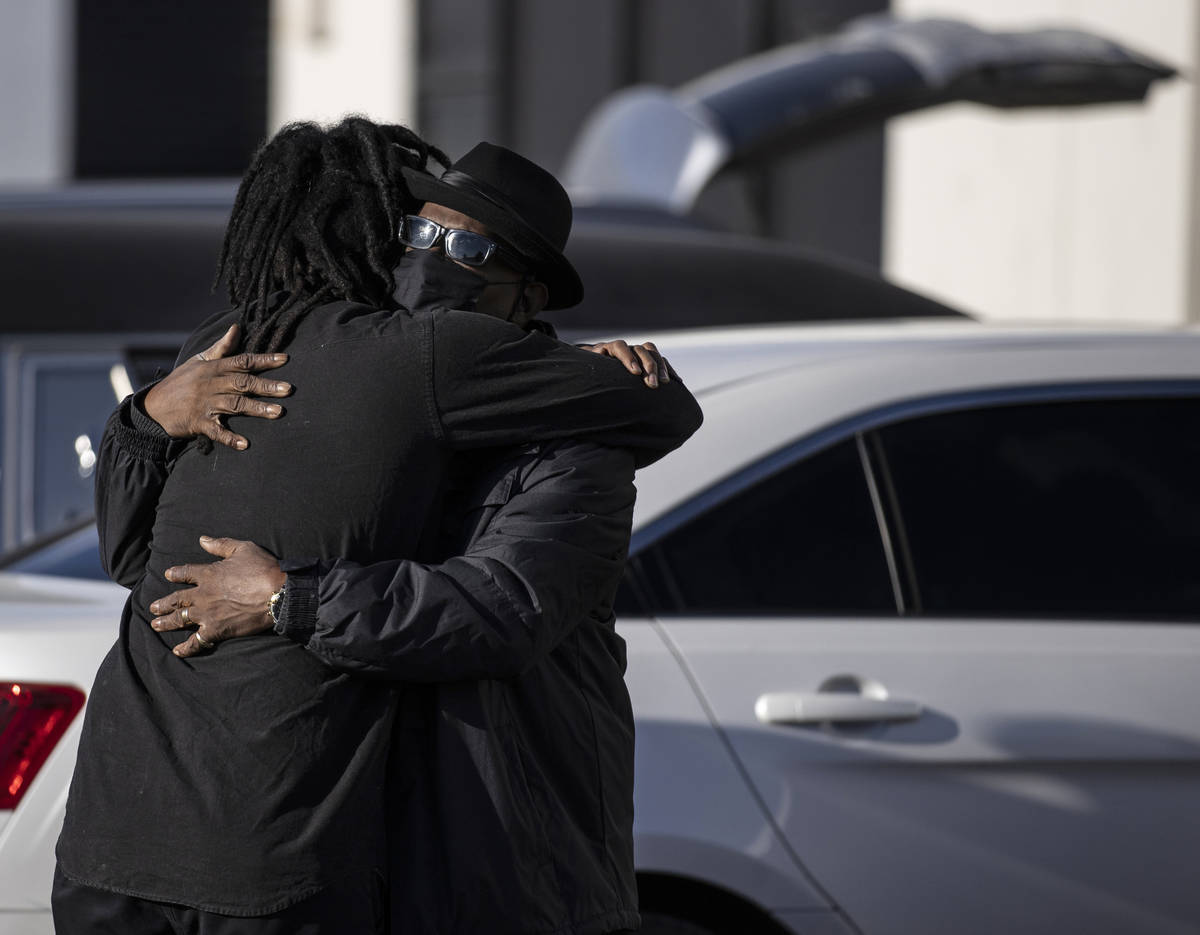 Steve Atkins, right, hugs his son Ace Atkins outside Hites Funeral Home and Crematory during a ...