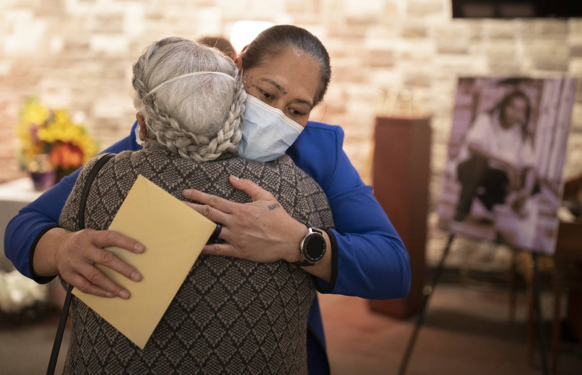 Evelini Gibbs, mother of Genesis Atkins, gets a hug during a memorial service for her son on S ...