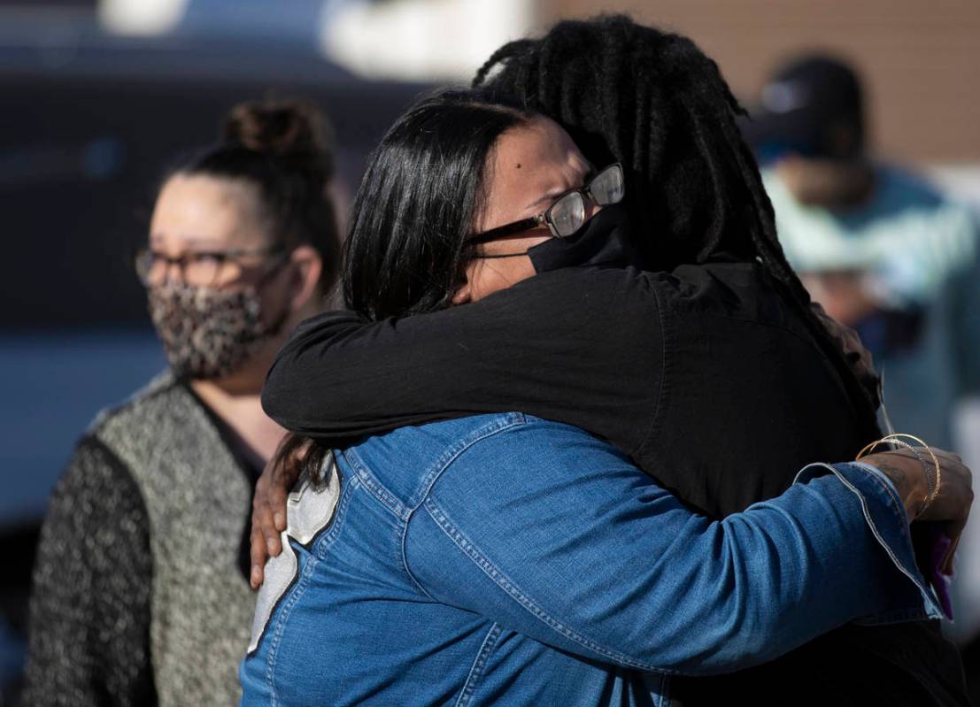 Friends and family grieve outside Hites Funeral Home and Crematory during a memorial service fo ...