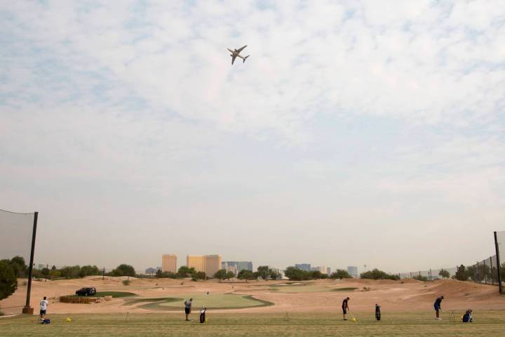 An airplane flies over Las Vegas Golf Center on Friday, Sept. 18, 2020, in Las Vegas. (Ellen Sc ...