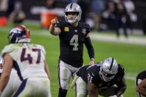 Las Vegas Raiders quarterback Derek Carr (4) audibles in the fourth quarter during an NFL footb ...