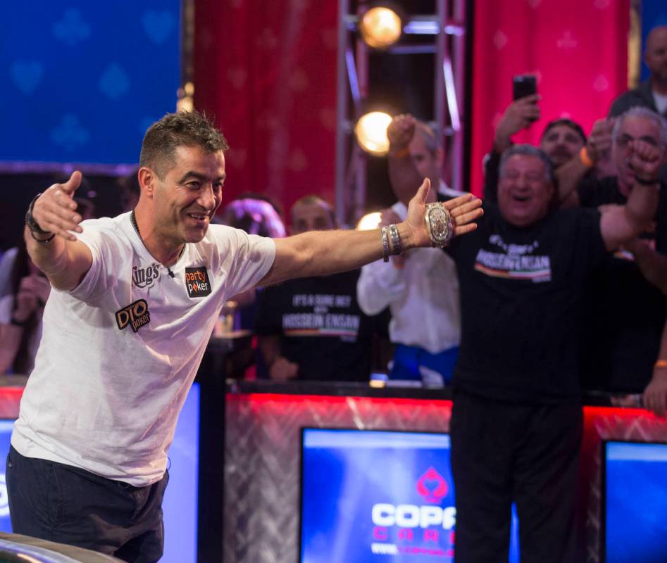 Hossein Ensan, left, from Germany, bows to his fans after winning the World Series of Poker Mai ...