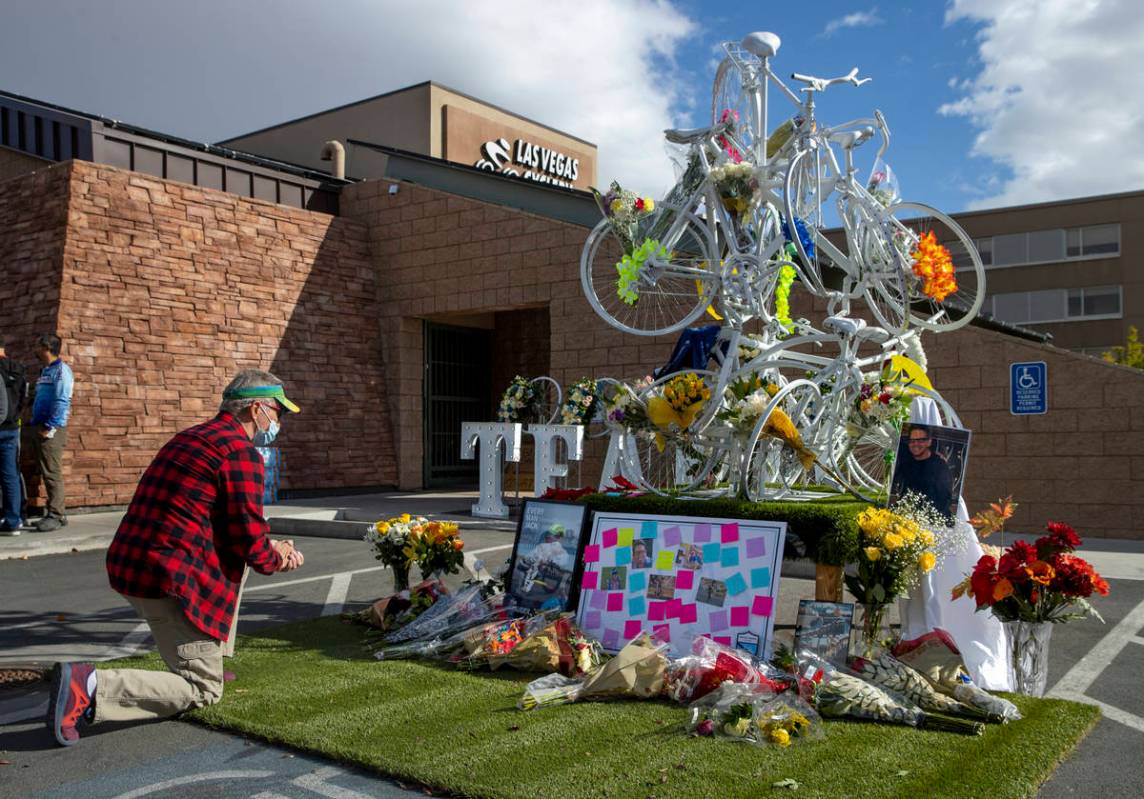 Victor Rodriguez kneels at a growing memorial during a vigil honoring the lives of five Las Veg ...