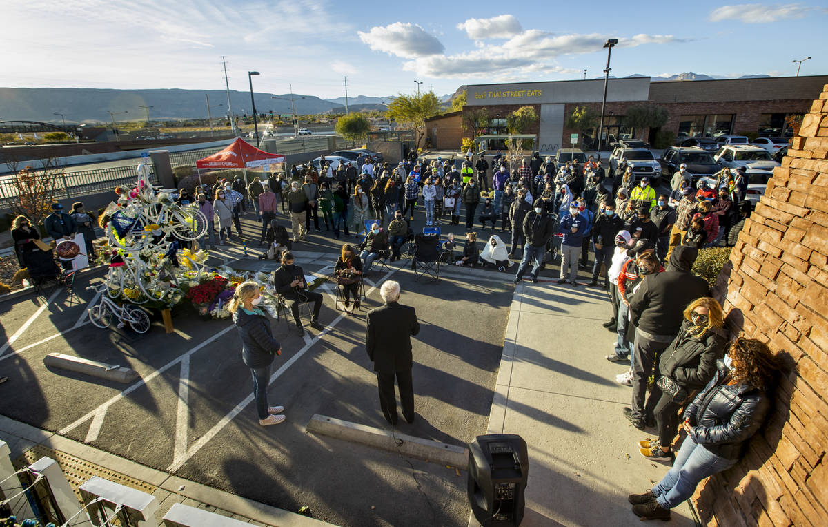 Attendees pray during a vigil honoring the lives of five Las Vegas cyclists who lost their live ...