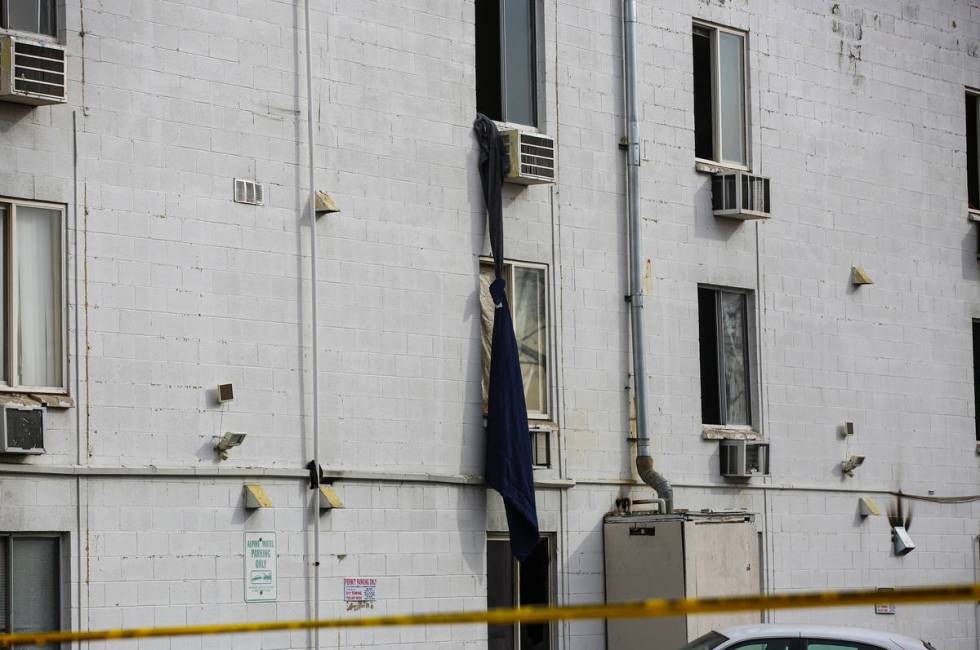 Sheets tied together hang from the third floor as firefighters respond to a fire at the Alpine ...