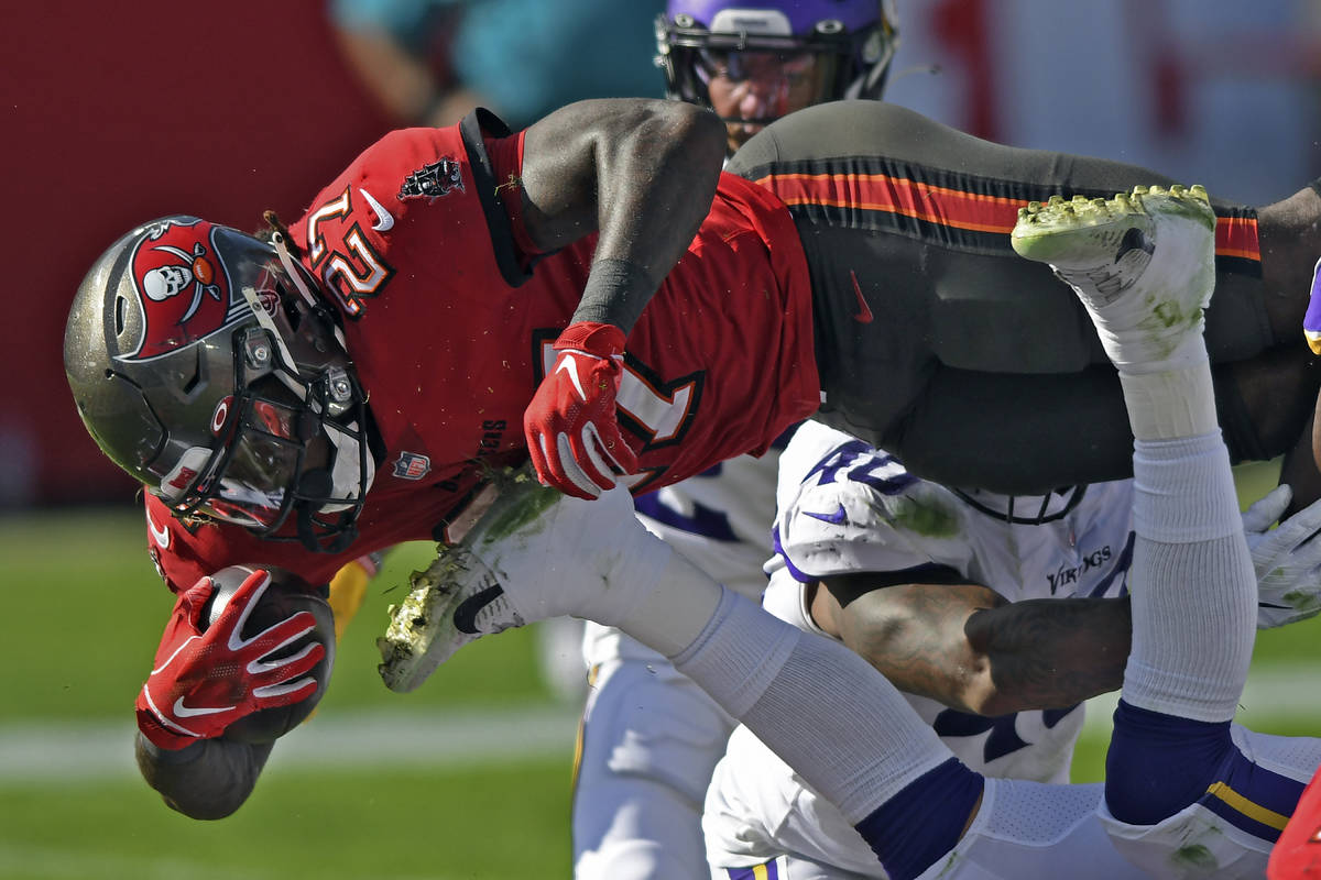 Tampa Bay Buccaneers running back Ronald Jones II (27) dives over the line to score on a 1-yard ...