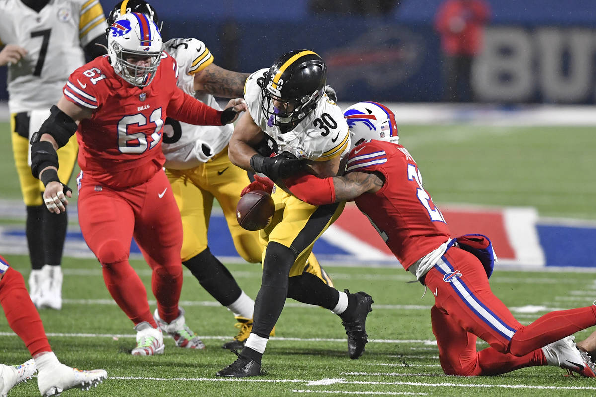 Buffalo Bills free safety Jordan Poyer, right, forces a fumble by Pittsburgh Steelers running b ...