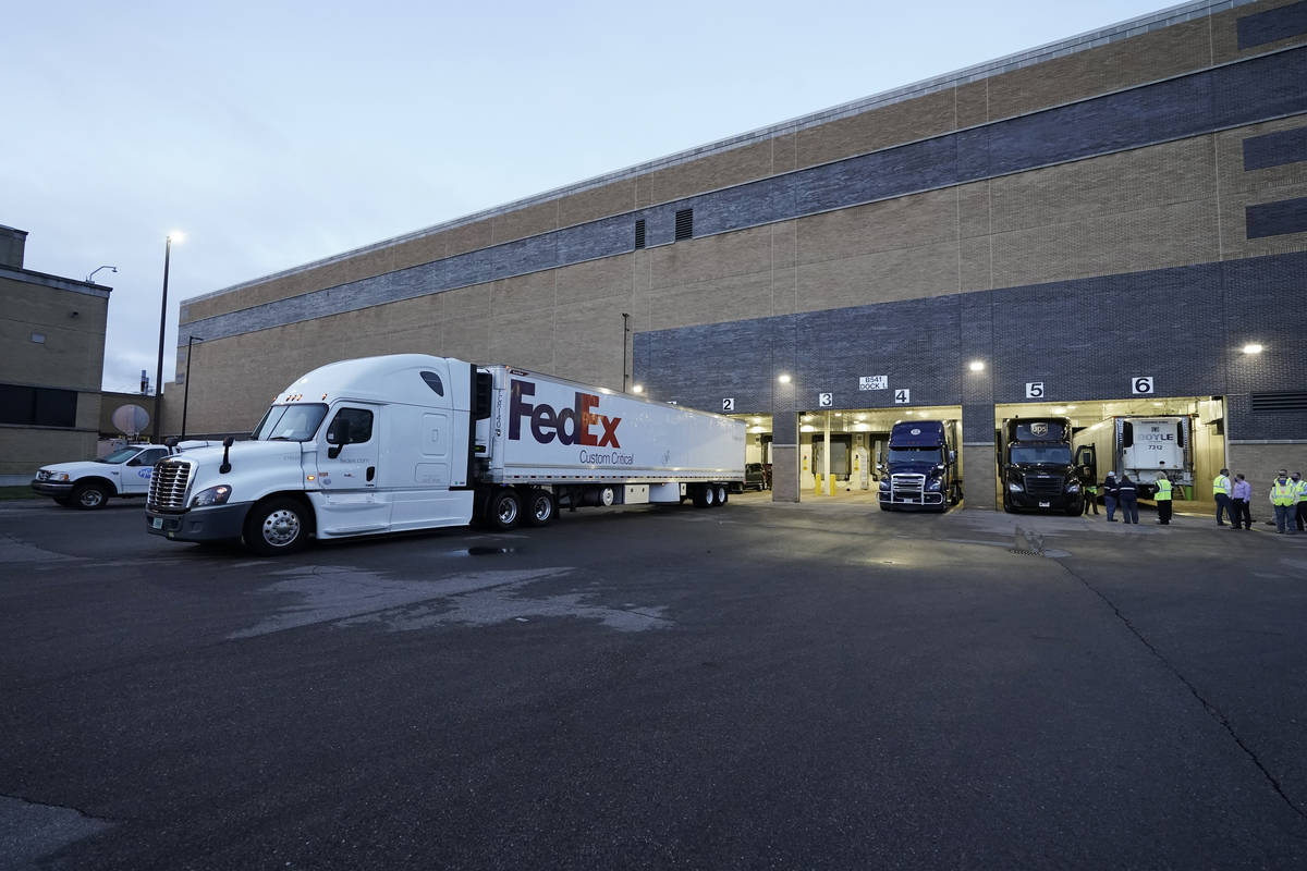 A truck loaded with the Pfizer-BioNTech COVID-19 vaccine leaves the Pfizer Global Supply Kalama ...