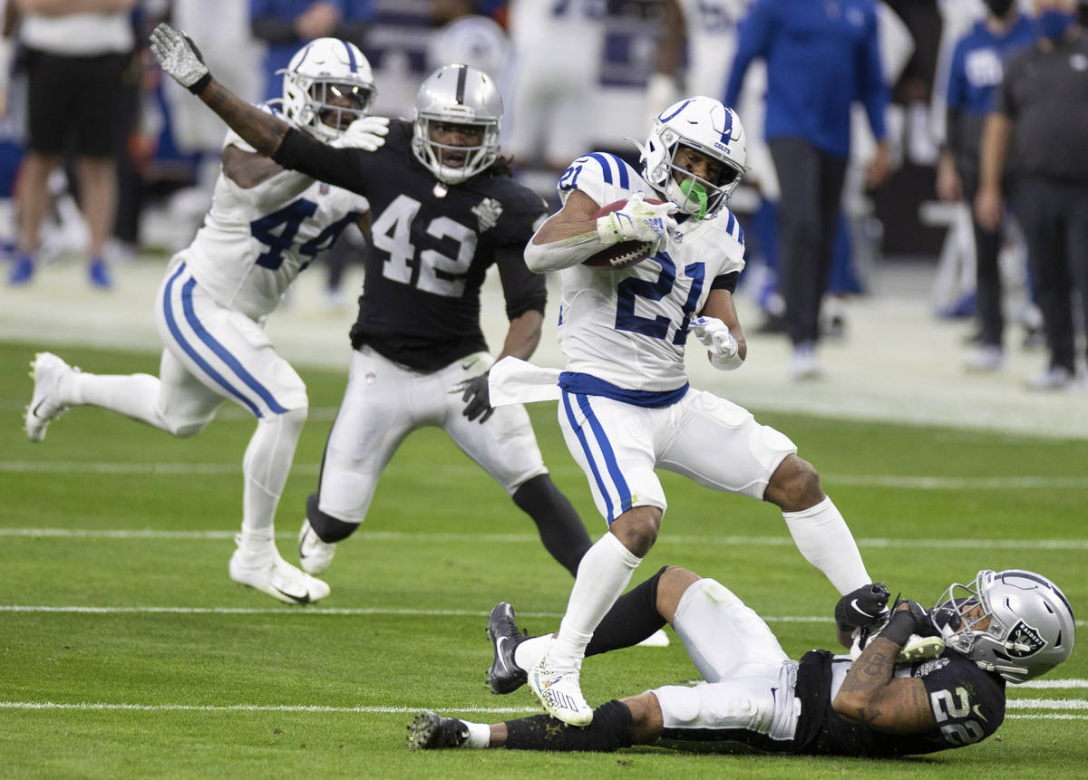 Indianapolis Colts running back Nyheim Hines (21) is tackled by Raiders cornerback Keisean Nixo ...