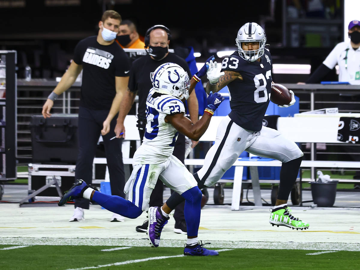 Raiders tight end Darren Waller (83) runs the ball against Indianapolis Colts cornerback Kenny ...
