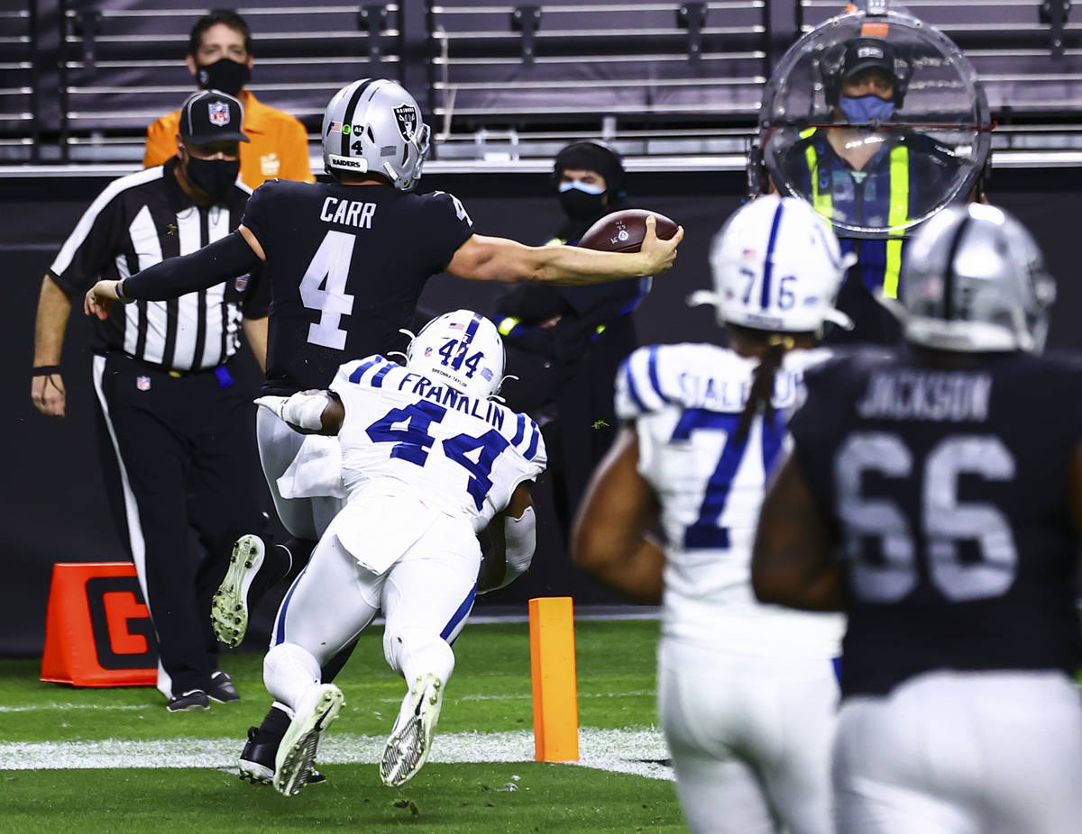 Raiders quarterback Derek Carr (4) scores a touchdown as Indianapolis Colts outside linebacker ...