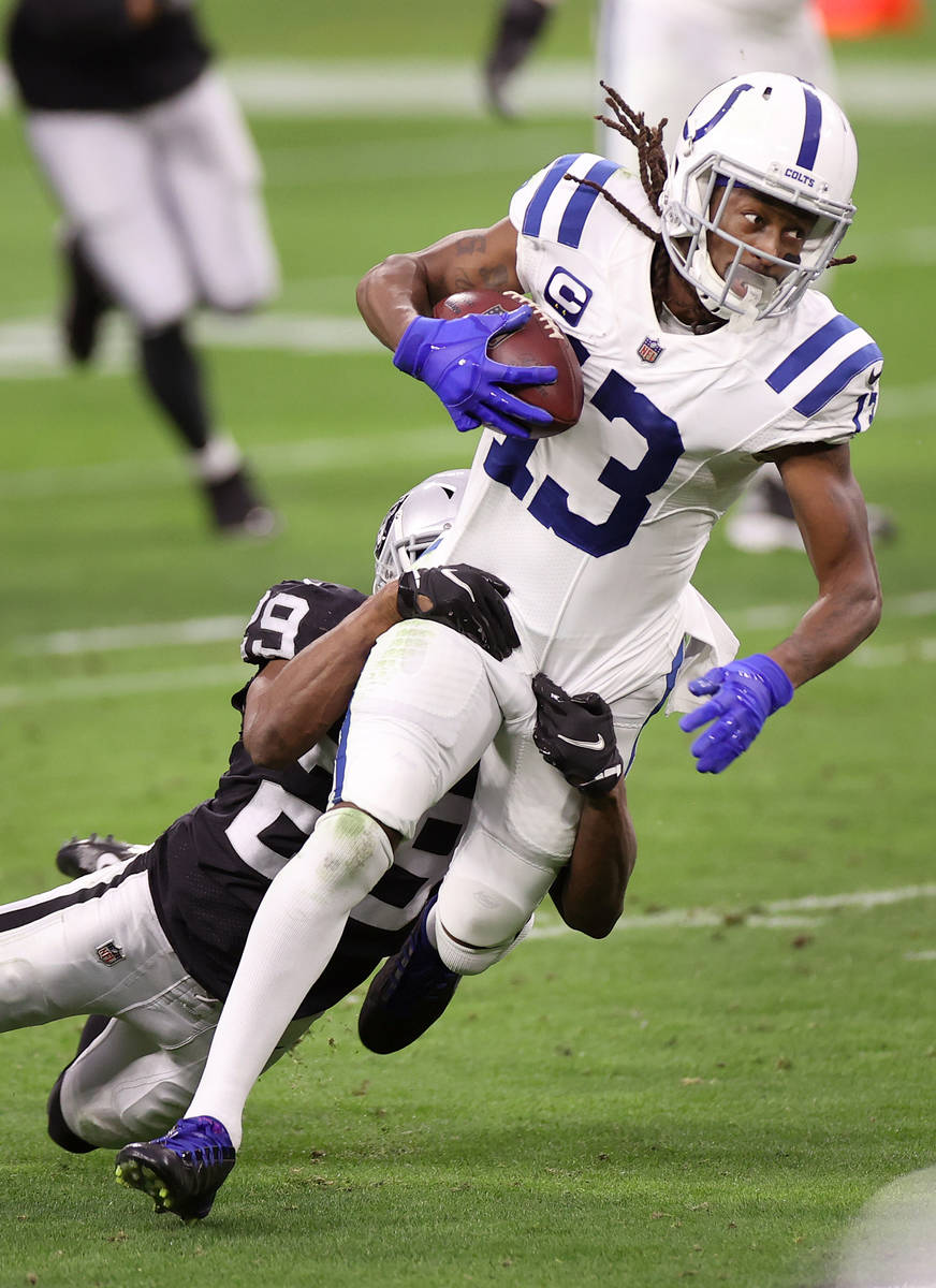 Indianapolis Colts wide receiver T.Y. Hilton (13) is tackled by Raiders free safety Lamarcus Jo ...