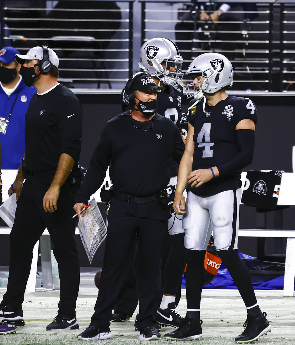 Raiders quarterback Derek Carr (4) talks with Raiders head coach Jon Gruden after his touchdown ...