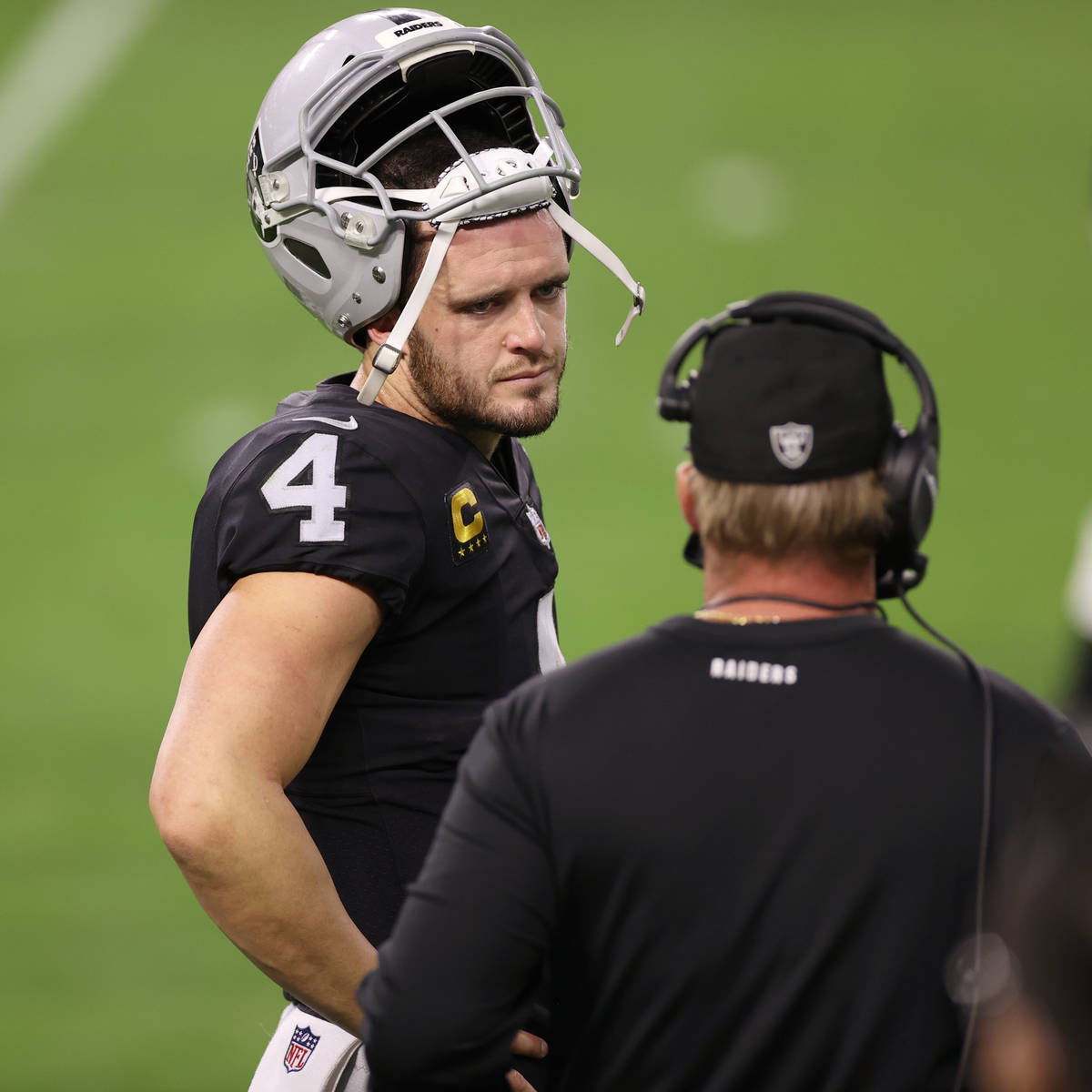 Raiders quarterback Derek Carr (4) talks to head coach Jon Gruden in the fourth quarter during ...