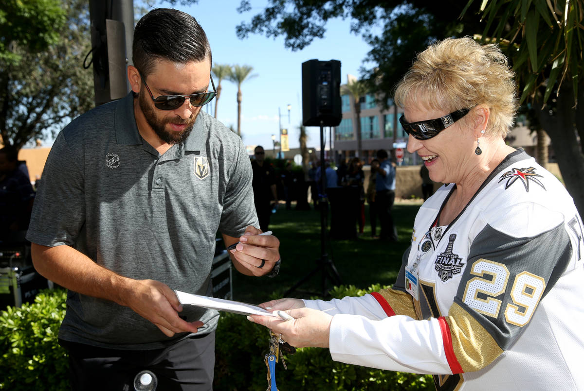 Vegas Golden Knights defenseman Deryk Engelland gives an autograph to Susan Onorato of Henderso ...
