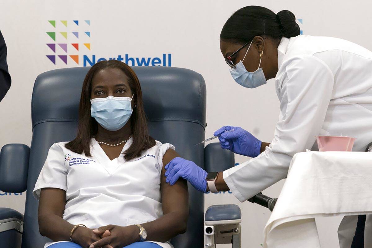 Sandra Lindsay, left, a nurse at Long Island Jewish Medical Center, is inoculated with the Pfiz ...