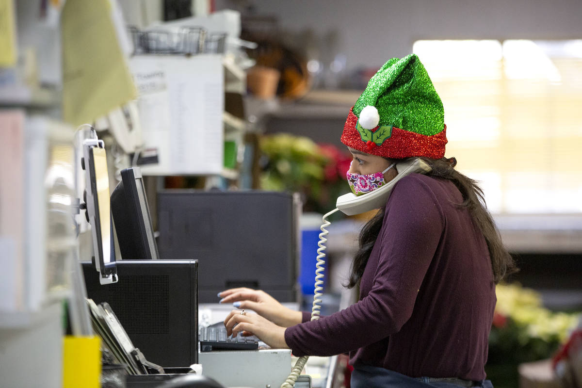 Kayla Sidecko, a sales clerk, answers the phone at DiBella Flowers & Gifts on Monday, Dec. ...