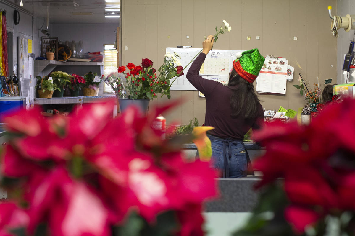 Kayla Sidecko designs a flower arrangement at DiBella Flowers & Gifts on Monday, Dec. 14, 2 ...