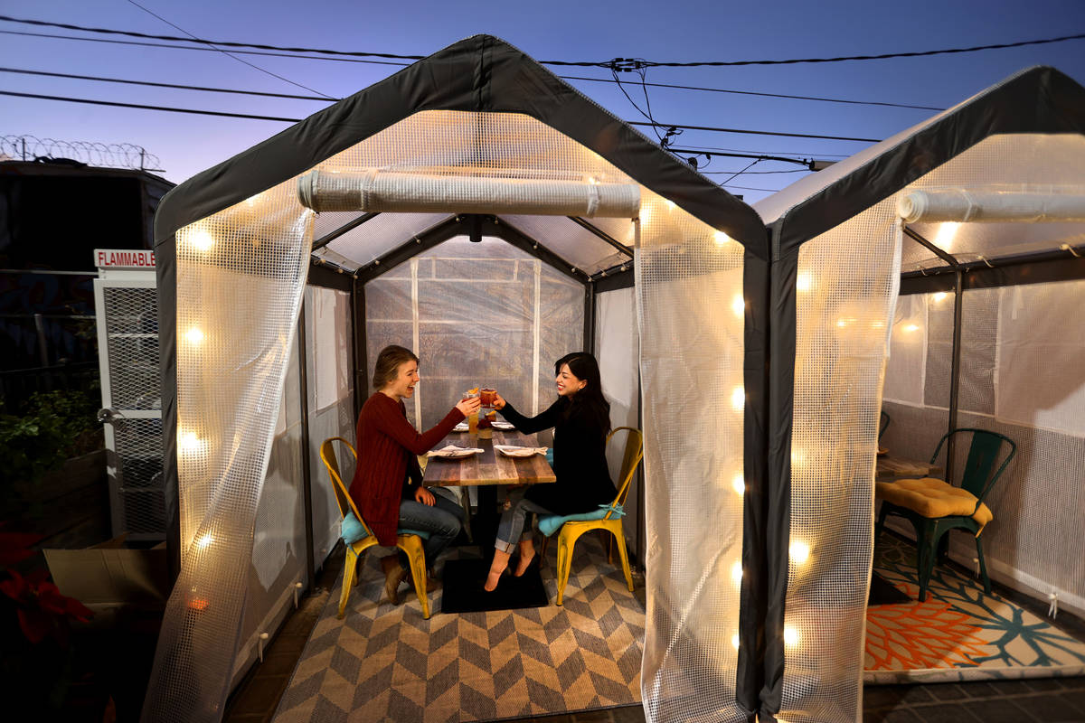 Kerry Callahan, left, and Aubree Toledo in an outdoor individual dinning tent at Esther's Kitch ...