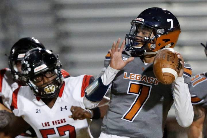 Legacy's quarterback Evan Olaes (7) looks to throw the ball as Las Vegas' Markell Jackson (57) ...