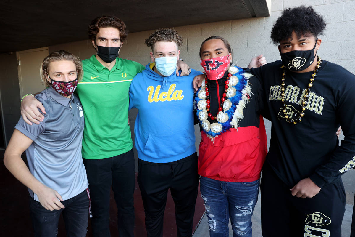 Liberty football players, from left, quarterback Daniel Britt, tight end Moliki Matavao, center ...