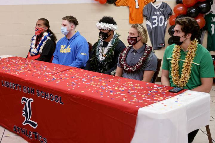 Liberty football players, from left, linebacker Zyrus Fiaseu, center Benjamin Roy, linebacker Z ...