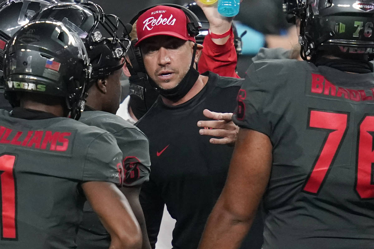 UNLV head coach Marcus Arroyo speaks with his players during the second half of an NCAA college ...