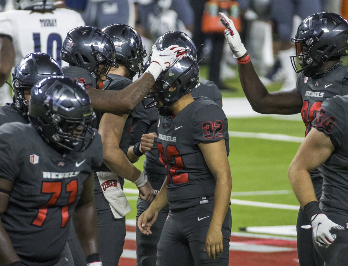 UNLV Rebels kicker Daniel Gutierrez (32, center) is congratulated on another field goal by team ...