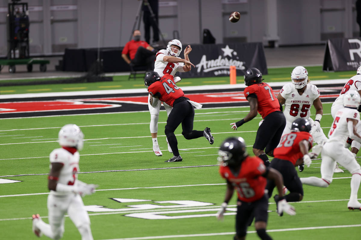 UNLV Rebels linebacker Malakai Salu (43) pressures Fresno State Bulldogs quarterback Ben Wooldr ...