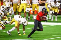 UNLV Rebels wide receiver Kyle Williams (1) runs the ball against the Wyoming Cowboys during th ...