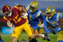 Southern California wide receiver Drake London, left, runs to the end zone for a touchdown whil ...