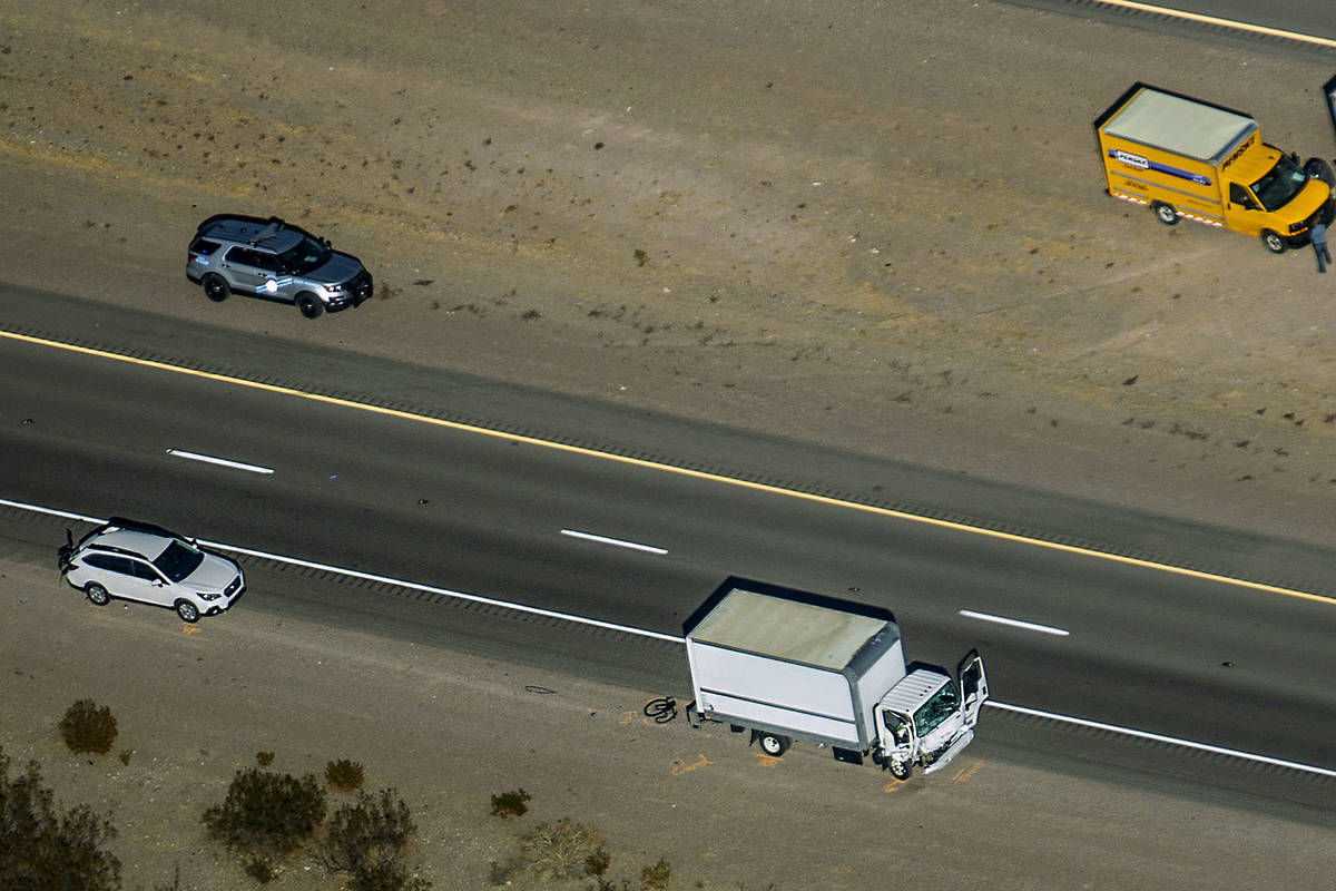 Damage to a truck is evident as the Nevada Highway Patrol works the scene of a fatal crash invo ...