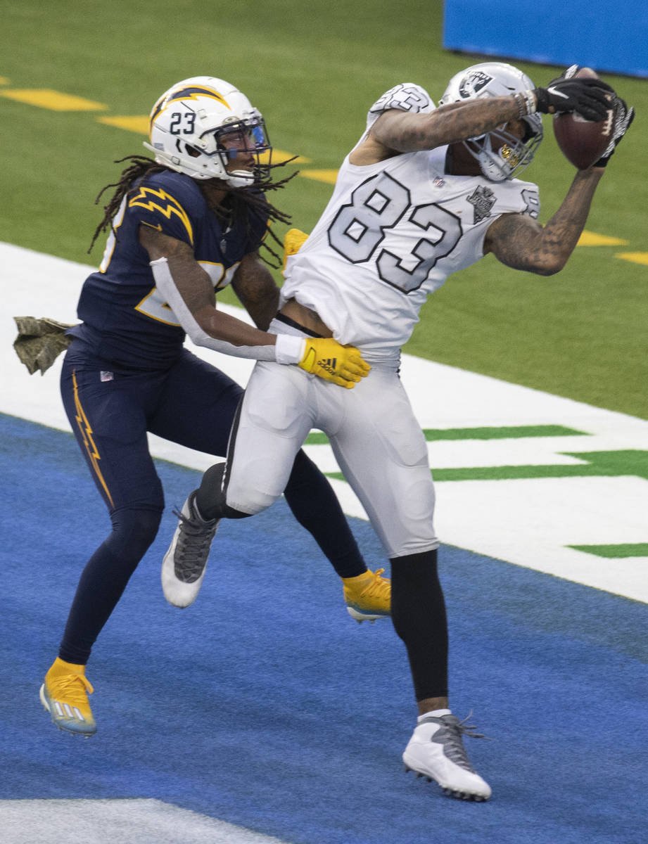 Las Vegas Raiders tight end Darren Waller (83) pulls in a touchdown pass over Los Angeles Charg ...