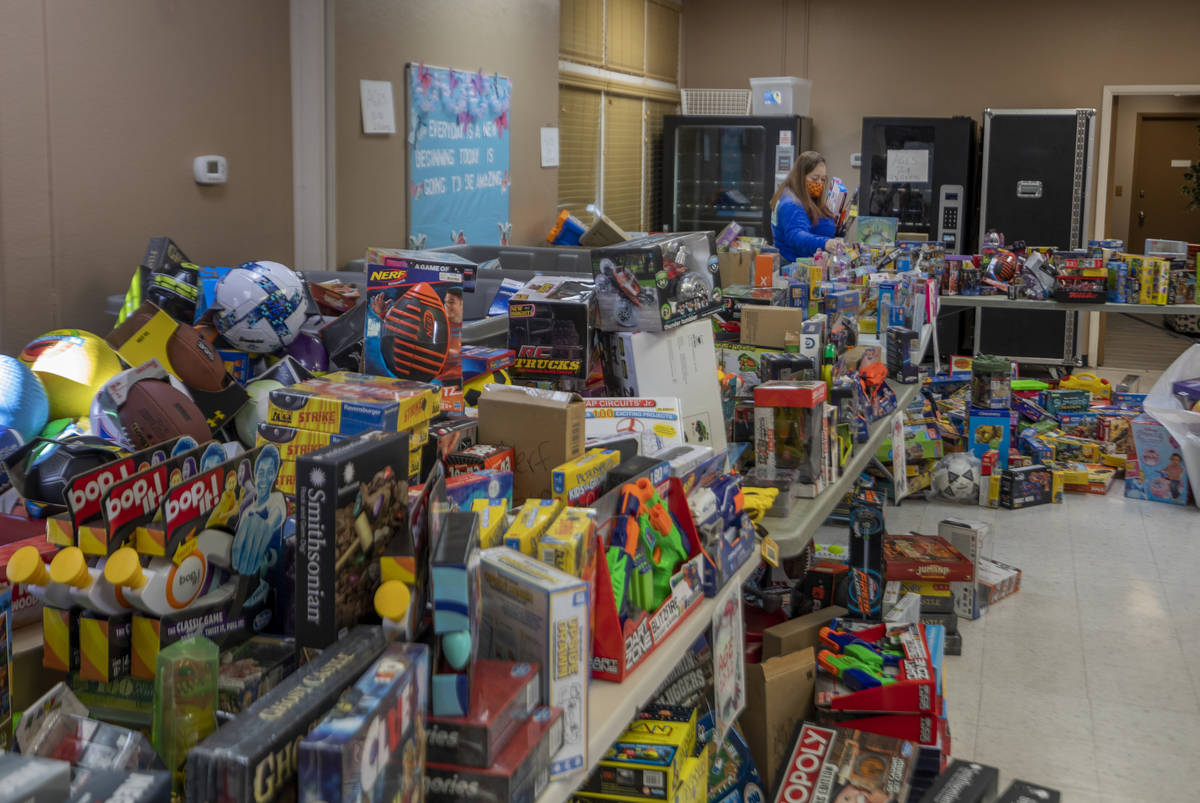 Volunteer Mandisa Alston, of Henderson packs toys for Christmas donations to be given to famili ...