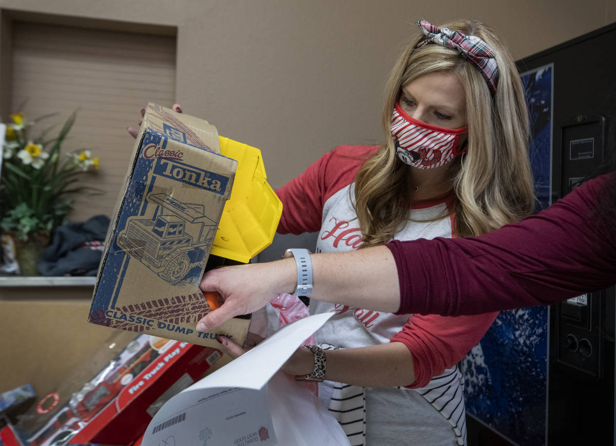 Lacie Jackson, 34, of Las Vegas, packs toys for Christmas donations to be given to families, at ...