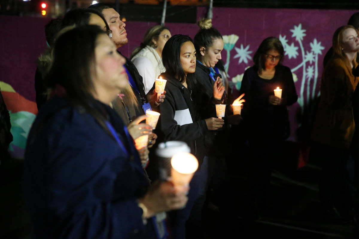 People attend a candlelight vigil to memorialize the homeless people of Las Vegas who died in t ...