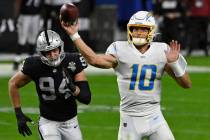 Los Angeles Chargers quarterback Justin Herbert (10) throws against the Las Vegas Raiders durin ...