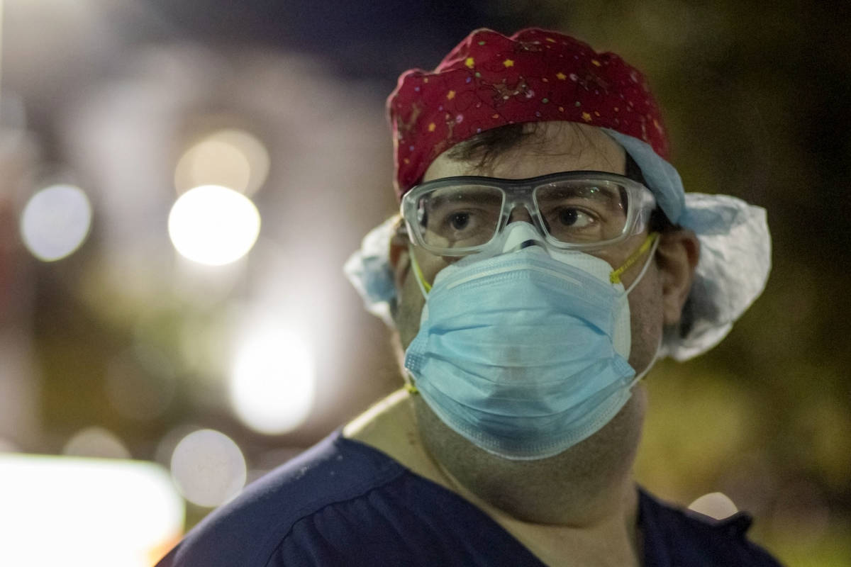 Zachary Pritchett, an intensive care nurse at St. Rose Dominican Hospital, Siena Campus, is see ...